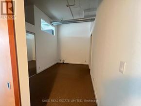 Toronto (Niagara) condo for rent - A room with white walls and a brown carpet.