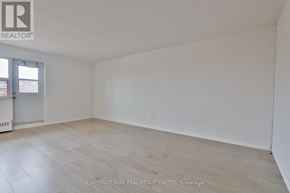 Oshawa (Lakeview) condo for rent - A room with a wooden floor and white walls, with a door on the left side.