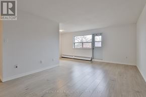 Oshawa (Lakeview) condo for rent - A spacious room with a window and a radiator.