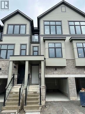 Oshawa (Donevan) townhouse for rent - A two story house with a garage underneath.