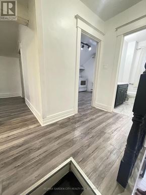 St. Catharines (E. Chester) multi-family for rent - A room with wooden flooring and white walls.