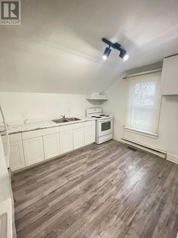 St. Catharines (E. Chester) multi-family for rent - A kitchen with white cabinets and a wooden floor.