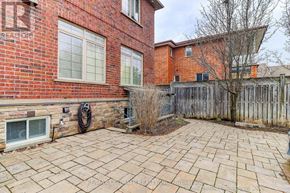 Toronto (Wexford-Maryvale) apartment for rent - A brick house with a patio and a tree.