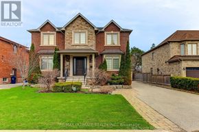 Toronto (Wexford-Maryvale) apartment for rent - A large, well-maintained house with a brick facade and a large front yard.