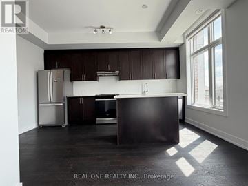 Vaughan (Sonoma Heights) townhouse for rent - A kitchen with dark wood cabinets and a stainless steel refrigerator.