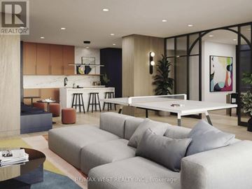 Burlington (Alton) condo for rent - A modern living room with a grey sofa and a coffee table.