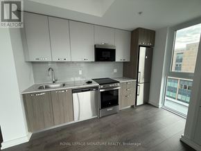 Hamilton (Corktown) condo for rent - A modern kitchen with a sink, stove, and refrigerator.