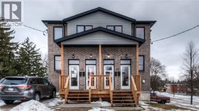 Kitchener apartment for rent - A house with a car parked in front of it.