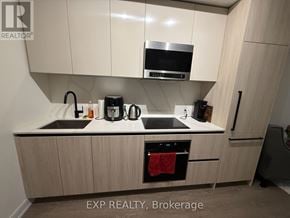 Toronto (Waterfront Communities) condo for rent - A kitchen with EXP REALTY, Brokerage watermark.