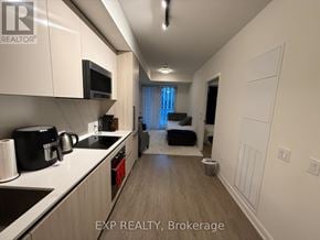 Toronto (Waterfront Communities) condo for rent - A kitchen with white cabinets and a black coffee maker.