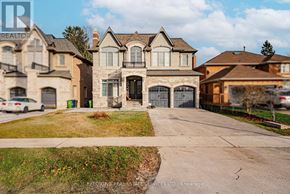 Toronto (Centennial Scarborough) apartment for rent - A large, multi-level house with a driveway in front.