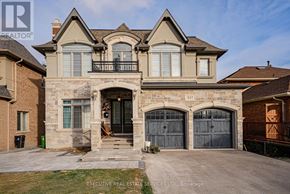 Toronto (Centennial Scarborough) apartment for rent - A large, luxurious house with a stone facade and a balcony is for sale.