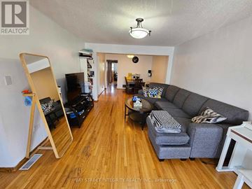 Mississauga (Rathwood) apartment for rent - A living room with a grey couch and wooden floors.