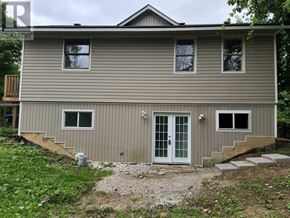 Innisfil (Alcona) apartment for rent - A house with a grey siding and a white door is shown.