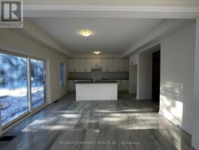 Oshawa (Eastdale) apartment for rent - A spacious kitchen and living room with a large island in the middle.