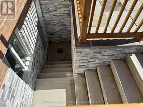 Richmond Hill (Rouge Woods) apartment for rent - A staircase with wooden steps and a stone wall.