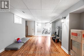 London East (East H) multi-family for rent - A room with a grey couch and a bicycle in the background.