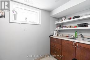 London East (East H) multi-family for rent - A kitchen with wooden cabinets and a white fridge.