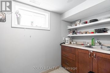 London East (East H) multi-family for rent - A kitchen with wooden cabinets and a white fridge.