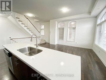 Whitchurch-Stouffville (Stouffville) townhouse for rent - A kitchen with a stainless steel sink and wooden floors.