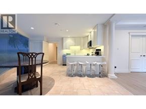 Vancouver apartment for rent - A well-lit kitchen with a bar stool and a dining table.