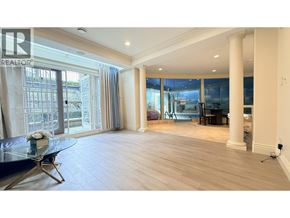 Vancouver apartment for rent - A spacious living room with a glass table and a view of the outside.