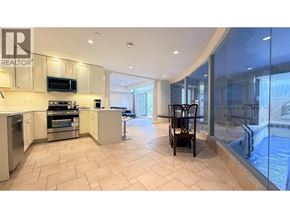 Vancouver apartment for rent - A modern kitchen with a glass wall leading to a balcony.