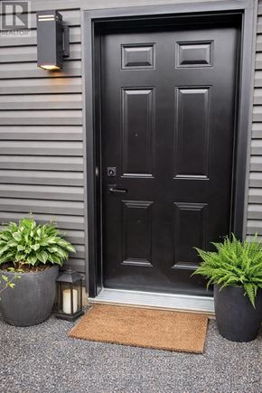 Russell apartment for rent - A black door with a mat in front of it.