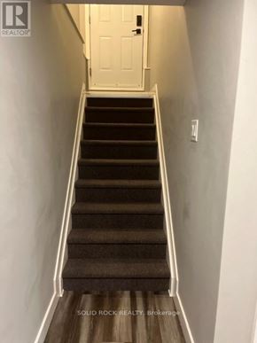 Russell apartment for rent - A staircase with a white door at the top.