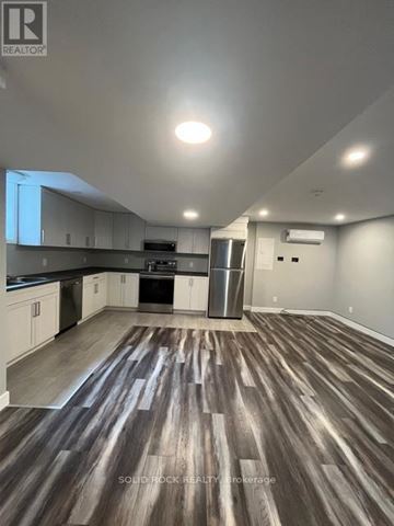 Russell apartment for rent - A kitchen with white cabinets and a wooden floor.