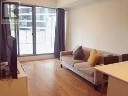 Toronto (Bay Street Corridor) condo for rent - A living room with a couch and a television.