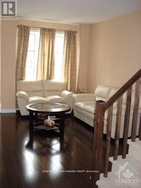 Ottawa townhouse for rent - A living room with a white couch and a coffee table.