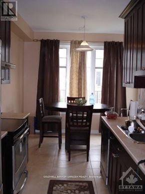 Ottawa townhouse for rent - A kitchen with brown curtains and a table set for two.