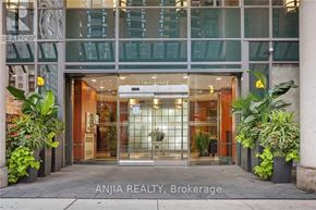 Toronto (Bay Street Corridor) condo for rent - The entrance to Anjia Realty Brokerage is shown with a glass door and potted plants on either side.