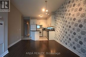 Toronto (Bay Street Corridor) condo for rent - A well-lit kitchen area with a patterned wallpaper and wooden flooring.