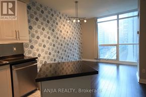 Toronto (Bay Street Corridor) condo for rent - A kitchen with a countertop and a wallpapered wall.
