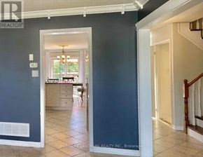 Wasaga Beach apartment for rent - A hallway with a staircase leading to the second floor.