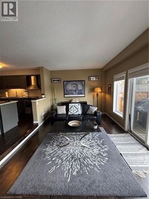 Waterloo townhouse for rent - A living room with a grey rug and a black and white couch.