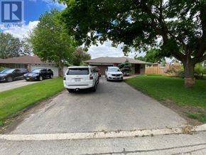 Markham (Bullock) apartment for rent - A white car is parked in front of a house with a sign that says REALTOR.