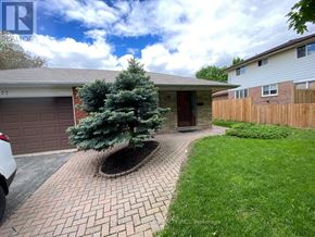 Markham (Bullock) apartment for rent - A house with a tree in a planter and a driveway.