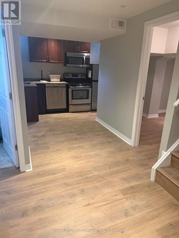 Vaughan (Vellore Village) apartment for rent - A kitchen with wooden floors and a stove top oven.