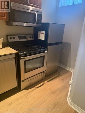 Vaughan (Vellore Village) apartment for rent - A kitchen with a stove top oven and a refrigerator.