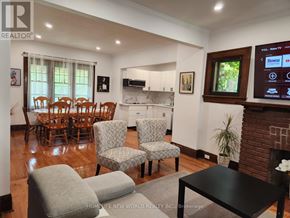 Niagara Falls (Cherrywood) apartment for rent - A living room with a fireplace and a TV mounted on the wall.