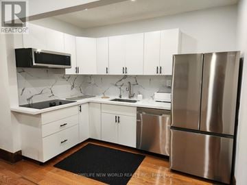 Niagara Falls (Cherrywood) apartment for rent - A modern kitchen with white cabinets and stainless steel appliances.