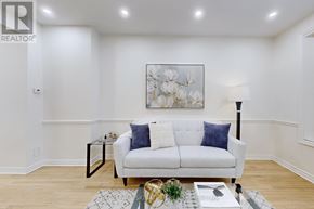 Toronto (Rosedale-Moore Park) apartment for rent - A living room with a white couch and a painting on the wall.