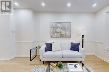 Toronto (Rosedale-Moore Park) apartment for rent - A living room with a white couch and a painting on the wall.