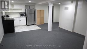 Pickering (Brock Ridge) apartment for rent - A kitchen area with a refrigerator, toaster, and cabinets.