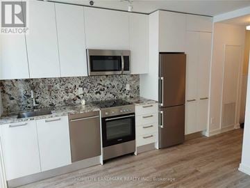 Toronto (Church-Yonge Corridor) condo for rent - A kitchen with white cabinets and a granite countertop.
