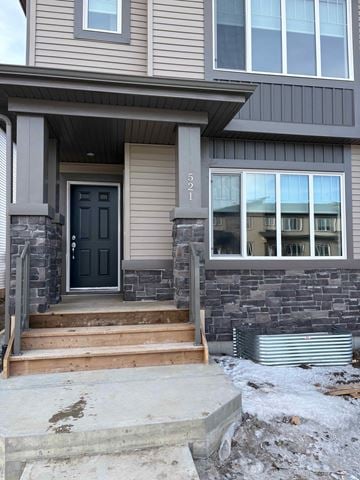 Leduc apartment for rent - A grey house with a black door and a window with a number 521 on it.