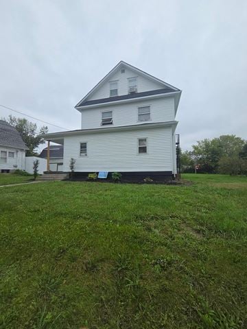 Lima apartment for rent - A white house with a grey roof and a green lawn in front.